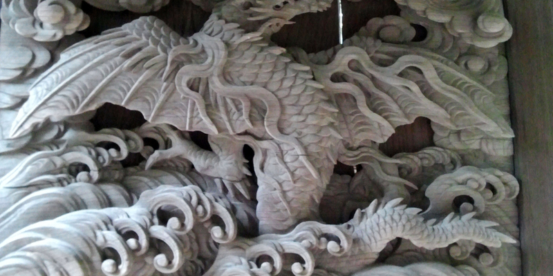  A dragon carved into a temple door. Dragons with water are popular in Buddhist temples.